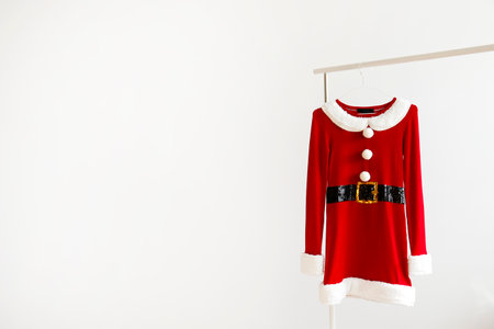 santa claus clothes hanging on a hanger on white backgroundの写真素材