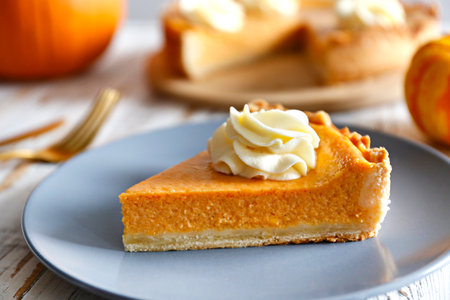 Pumpkin pie with whipped cream on a gray plate, horizontalの写真素材