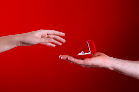 She said yes concept. Cropped shot of male and female hands reaching to each other. Man makes a proposal to his girlfriend. Close up, top view, copy space for text.の写真素材