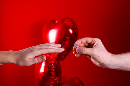 She said yes concept. Cropped shot of male and female hands reaching to each other. Man makes a proposal to his girlfriend. Close up, top view, copy space for text.の写真素材