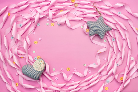 Textile toy heart and star on a festive background of satin ribbon.の写真素材