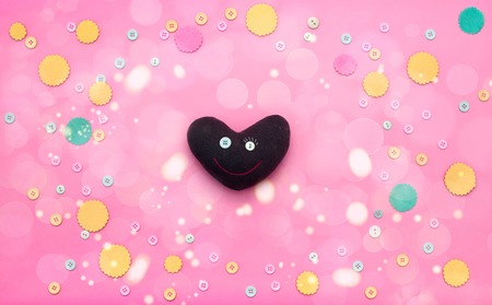 Decorative heart on a festive background. The concept of Valentine's day. Decorative buttons top viewの写真素材