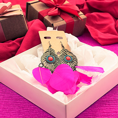 Festive packaging gift boxes Decorated with satin ribbon bow. Earrings gift for women.の写真素材