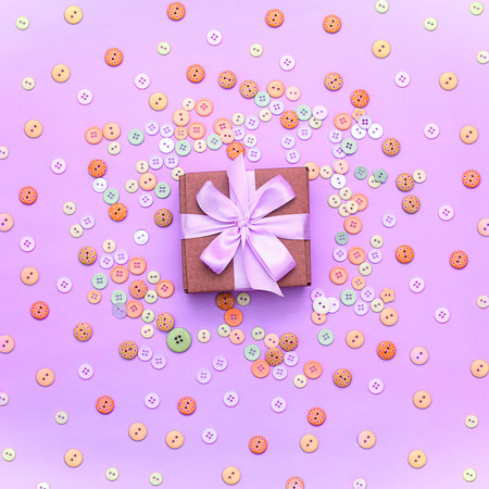 Decorative gift box with a colored background. Top view Flat Lay