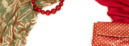 Banner Decorative draping frame of the textile. Women accessories scarf red pattern British flag beads gift bag. White background top viewの写真素材
