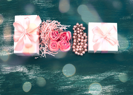 Festive composition box packing with gifts. Women's jewelry is packaged in a box with a bow on a grey shabby background. Top view Flat Layの写真素材