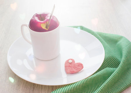 Fruit tea in a white Cup with a lid from Apple. Breakfast. The concept of Valentine's dayの写真素材