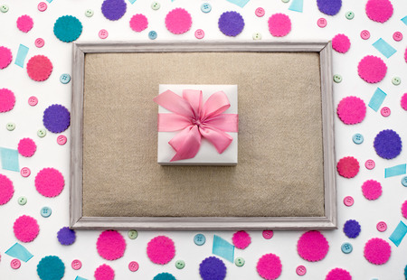 Decorative festive background with colored confetti Box with gift . Top view decor for a carnival partyの写真素材