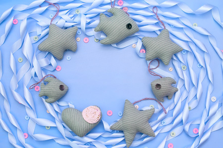 Textile toy heart and star on a festive background of satin ribbon. Decorative buttons top viewの写真素材