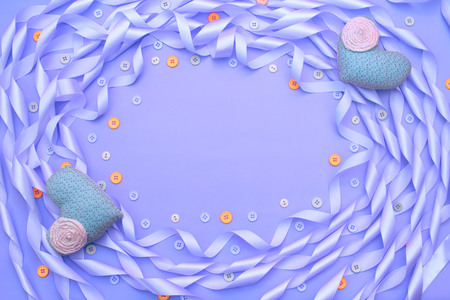 Decorative frame of satin ribbon purple. Gift box decorated with a bow. Background purpleの写真素材