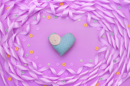 Decorative frame of satin ribbon purple. Gift box decorated with a bow. Background purpleの写真素材