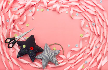 Textile toy heart and star on a festive background of satin ribbon. Decorative buttons top viewの写真素材