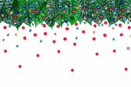 Natural holiday background with green leaves on a white background.