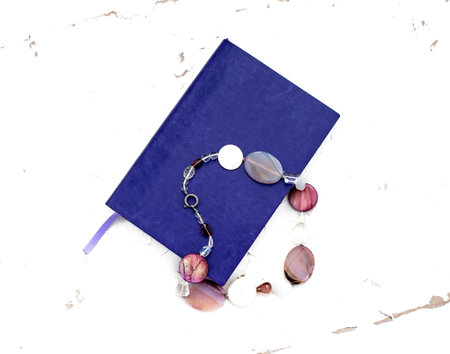 Notebook for school and office. Purple on a white background. Beads made of natural stone
