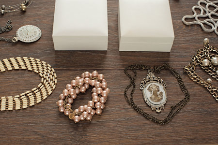 Vintage composition lay flat jewelry for women and gift packaging. The view from the top. Wooden dark backgroundの写真素材
