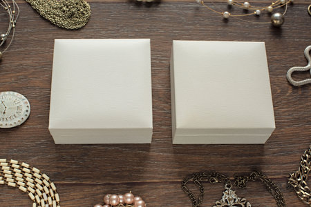 Vintage composition lay flat jewelry for women and gift packaging. The view from the top. Wooden dark backgroundの写真素材