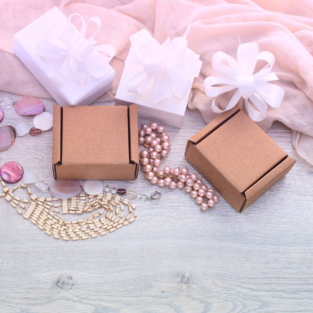 Wrapping gifts for the holiday. Beautiful jewelry for woman top view lay flatの写真素材