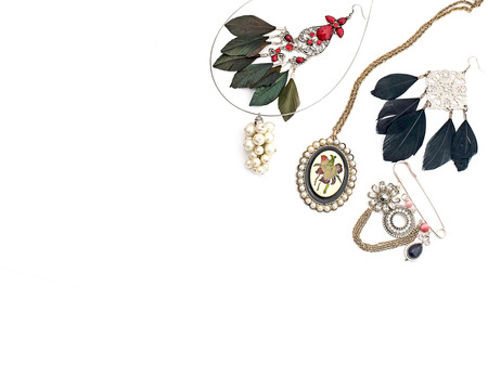 Fashionable jewelry for women on a white background. Beads, necklace, earrings with feathers.の写真素材