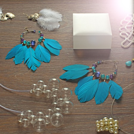 A set of jewelry for the woman on wooden background. The view from the top. The concept of fashion and designの写真素材