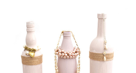 Bottle for home decoration on textured background. Paint, decor twine. Women's jewellery, necklace, bracelet.の写真素材