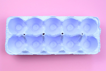 Stand for eggs purple on a pink background. Surrealism. Flat lay top viewの写真素材