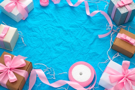 Decorative festive background with gift boxes. Textured blue candy background. Flat lay top viewの写真素材