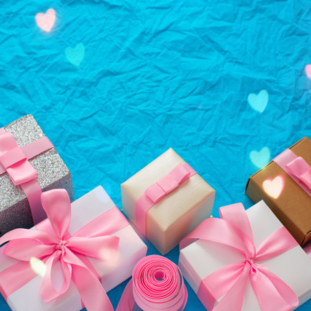 Decorative festive background with gift boxes. Textured blue candy background. Flat lay top viewの写真素材