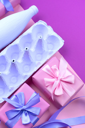 Stand for eggs purple on a pink background. Surrealism. Flat lay top view. Ultravioletの写真素材