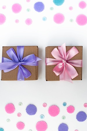 Two Gift boxes on festive background of pastel confetti. Flat top viewの写真素材