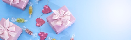 Banner Decorative festive background with gift boxes. Textured blue candy background. Flat lay top viewの写真素材