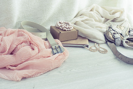 A set of women's Fashion accessories shopping Jewelry Scarf. Wooden background with place for textの写真素材