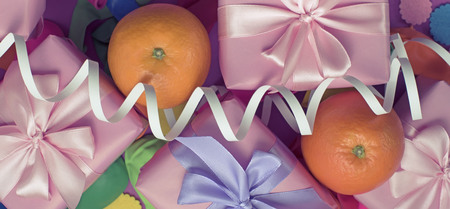 Banner Decorative composition five boxes with gifts Satin ribbon Bow Oranges Confetti Serpentine birthday party. The view from the topの写真素材