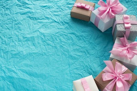 Decorative festive background with gift boxes. Textured blue candy background. Flat lay top viewの写真素材