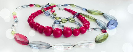 Banner Fashion Accessories Beads costume Jewelry on a light Colored background is Red. Top view Garland Festive backgroundの写真素材