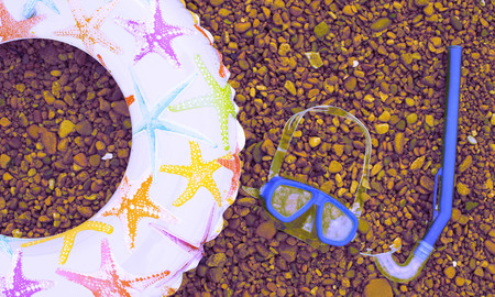 Surrealism Banner Beach accessories on the sea pebble. Lifeline Underwater mask Tube Sandals. Flat lay top viewの写真素材