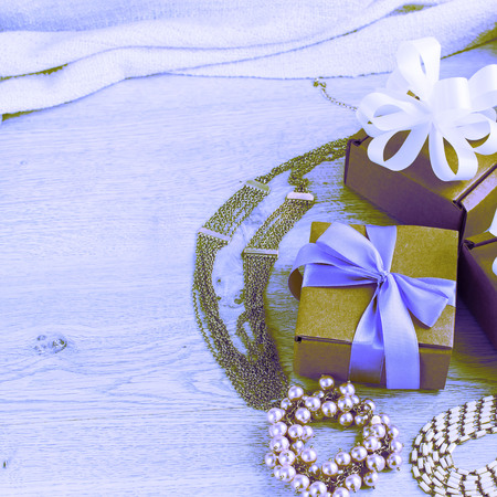 Surrealism gift boxes with gifts. Women's jewelry on a light wooden background.の写真素材