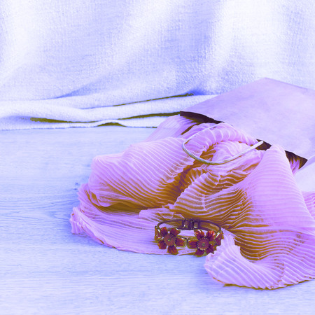 Surrealism A set of women's Fashion accessories shopping Jewelry Scarf. Wooden background with place for textの写真素材