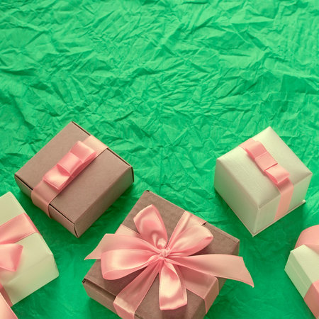 Decorative festive background with gift boxes. Textured green background. Flat lay top view