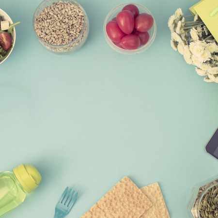 A set of useful products, cherry Tomato, apple fruit Seeds Plastic Tableware White Flowers Fresh Salad top View Copy Space for Text Flat Layの写真素材