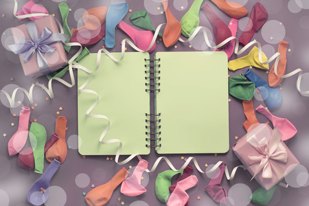 Festive background decorative composition materials notebook for celebration and decoration. The view from the top flat lay. Purple Pink background. Toningの写真素材
