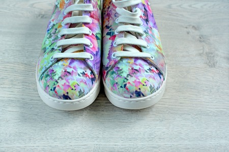 Women's fashion sneakers on the hardwood a light background. Top view copy spaceの写真素材