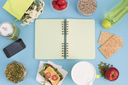 A set of useful products, cherry Tomato, apple fruit Seeds Plastic Tableware White Flowers Fresh Salad top View Copy Space for Text Flat Layの写真素材