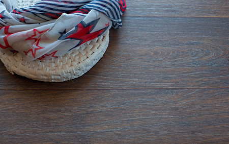 Lightweight summer scarf on wooden background. The view from the top. The concept of fashion and designの写真素材