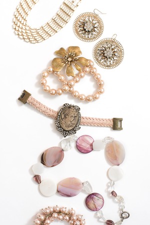 Set of womens jewelry in vintage style necklace cameo pearl bracelet chain earrings on white background.の写真素材