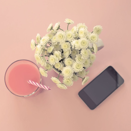 Bouquet of chrysanthemum flowers in a Cup of tea glass cocktail phone.の写真素材