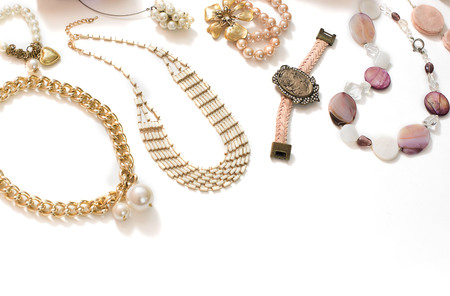 Set of womens jewelry in vintage style necklace cameo pearl bracelet chain earrings on white background.の写真素材