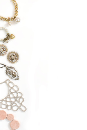 Set of women's jewelry in vintage style necklace cameo pearl bracelet chain earrings on white background. The view from the top lay flat.の写真素材