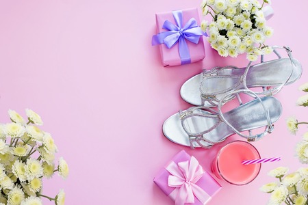 Gift box with satin ribbon bow for women Flowers Buy Shoes a Glass of Cocktail. Set of festive items flat lay top viewの写真素材
