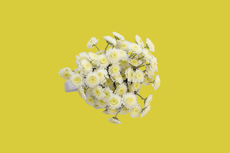 Bouquet of chrysanthemums on a yellow background. Top view copy space flat layの写真素材