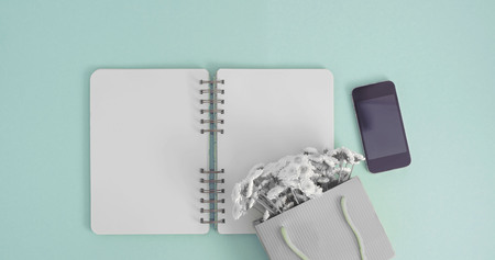 Banner Open notebook for records lies on the surface of the cocktail pink glass tube bouquet of chrysanthemums. The pastel blue background copy spaceの写真素材